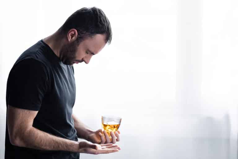 depressed man mixing Zoloft and Alcohol