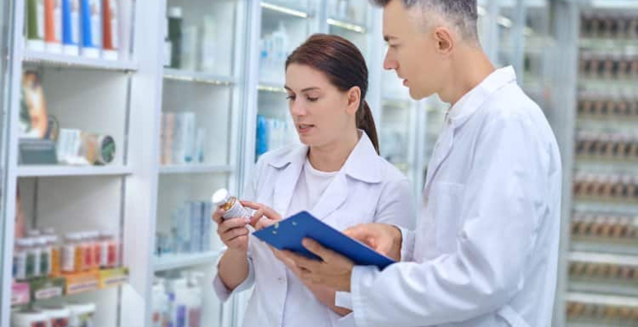Two pharmacists discussing medications in a pharmacy