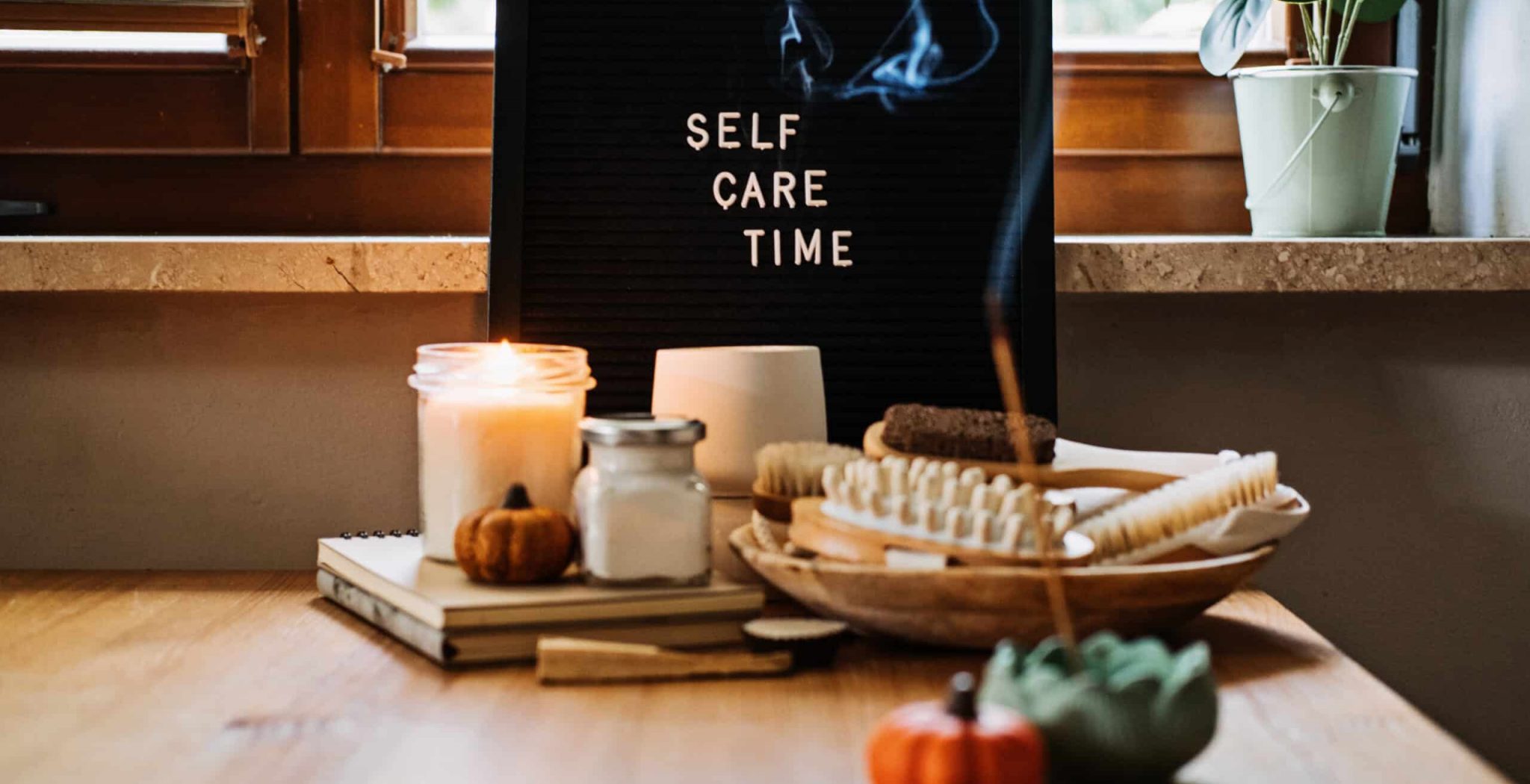 Self-care, Wellness in autumn, winter cold season. Letter board text Self Care Time, aroma sticks, body and self-care handmade cosmetics and beauty product and decor pumpkins.